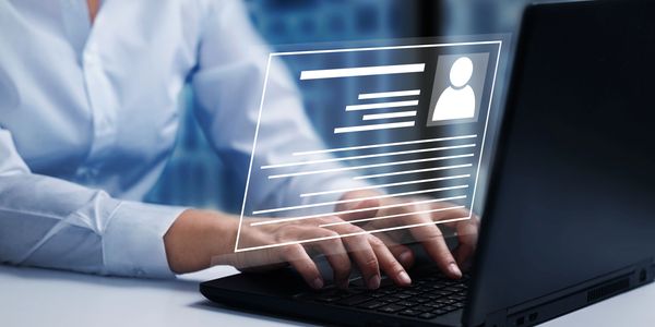 Digital profile illustration over a person using a laptop