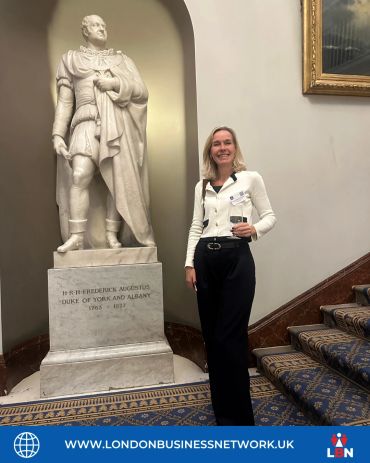 Participant standing beside a statue at an LBN venue