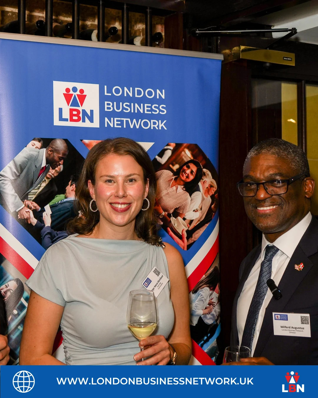 Two participants in front of the London Business Network banner